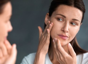 sebium_maskne-women-checking-acne-mirror